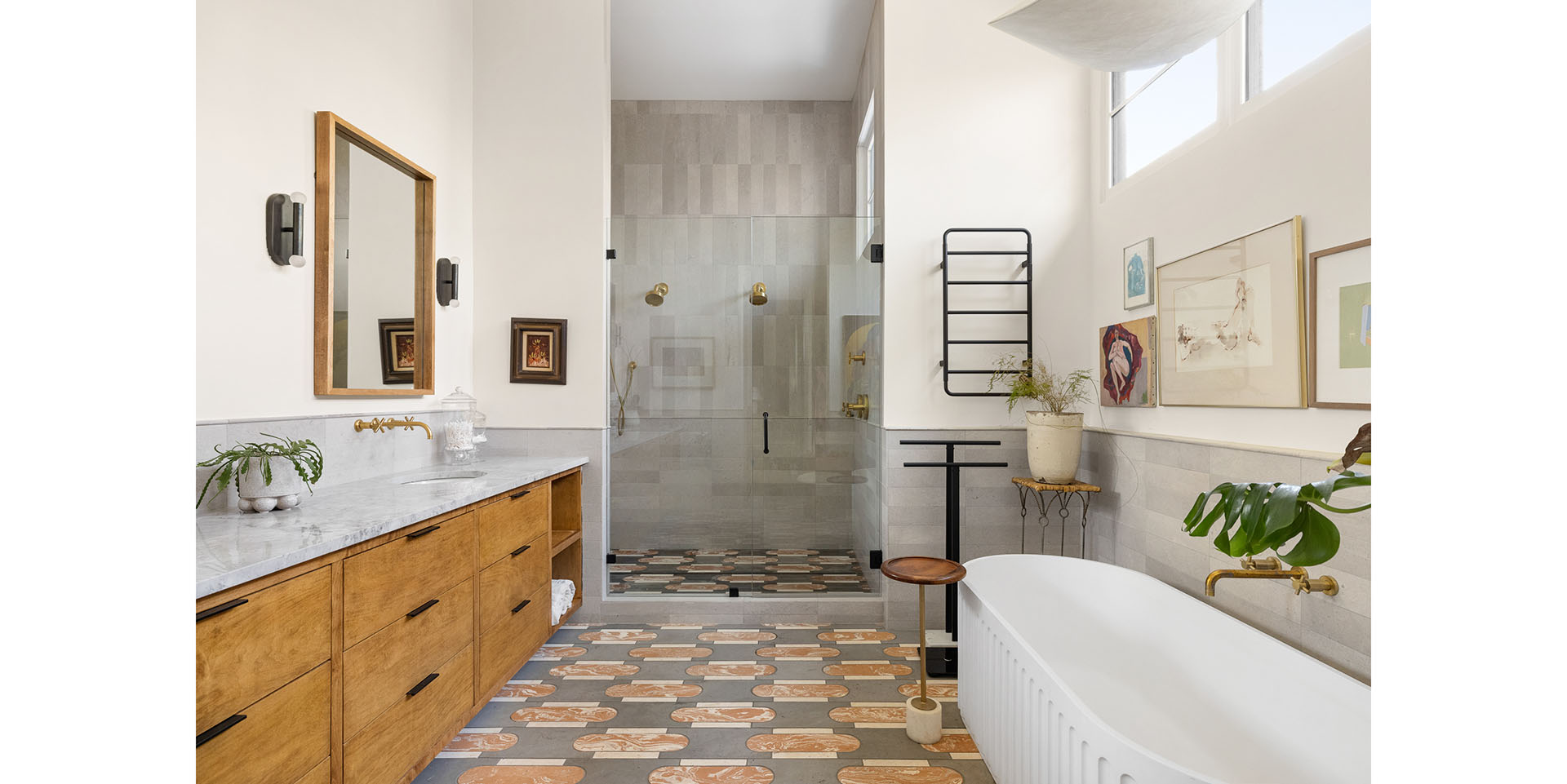 Modern bathroom with a freestanding white tub, glass shower enclosure, and a wooden vanity with marble countertop
