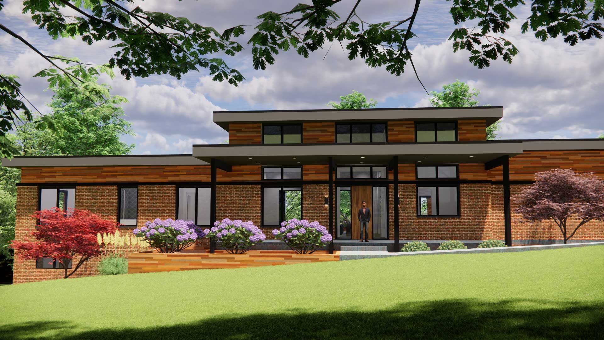 Modern two-story brick-and-wood house with large glass doors, landscaped front yard, and a person standing on the entry steps.