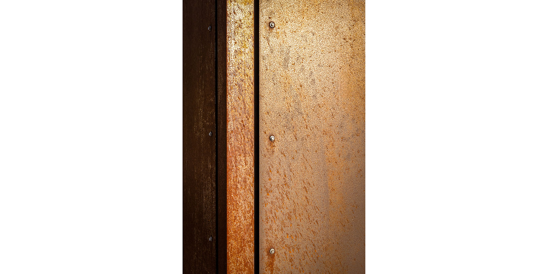 Rusty brown metal panels with visible screws between dark wooden boards, seen in a vertical strip arrangement.